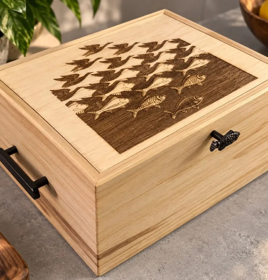 Light wood box with a detailed engraved fish design